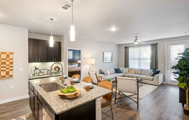 a living room with a kitchen and a dining room