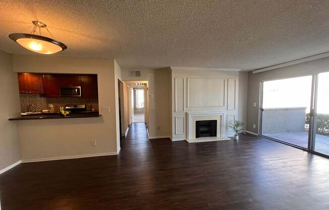 A spacious living room with a fireplace and sliding glass doors.