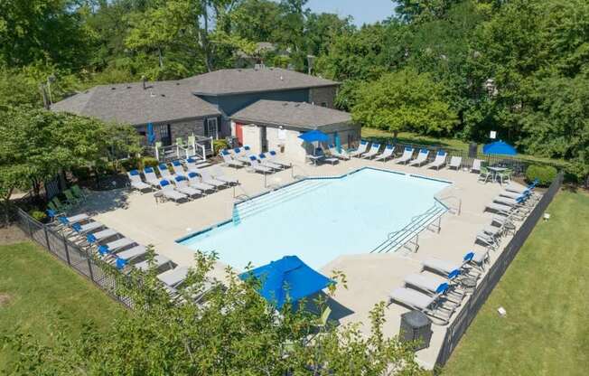 an aerial view of a resort style pool with lounge chairs and umbrellas at Station JTown, Louisville, KY