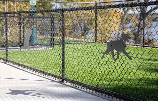 A dog silhouette is on the fence.