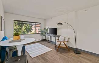 A living room with a white table and a television.