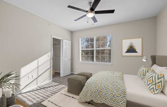 a bedroom with a large bed and a ceiling fan