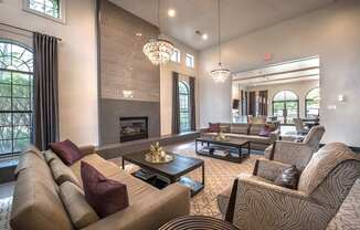 A living room with a fireplace and a chandelier.