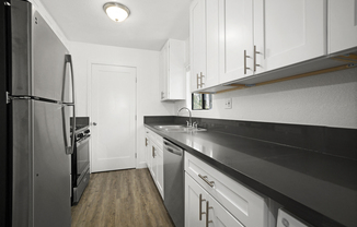 Apartments in Sherman Oaks for Rent - Brody Terrace - Modern Kitchen with Stainless Steel Appliances, Black Counter Tops & White Cabinets