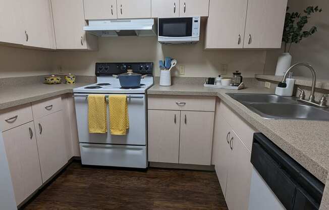 an empty kitchen with white cabinets and stainless steel appliances