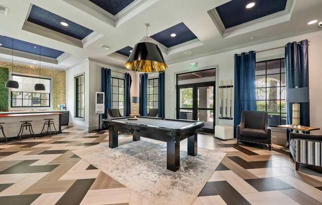 a game room with a pool table and a bar