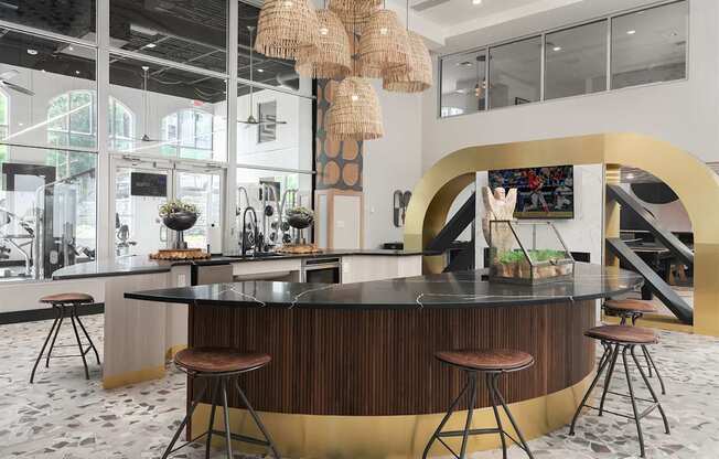 the lobby or reception area of a hotel with a bar and stools at The Heights Apartments, Cincinnati, Ohio