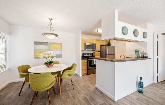 an open kitchen and dining room with a table and chairs