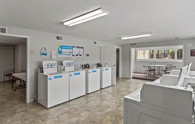 a group of washers and dryers in a room