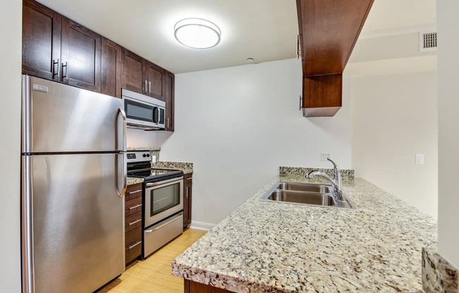 a kitchen with stainless steel appliances and granite counter tops