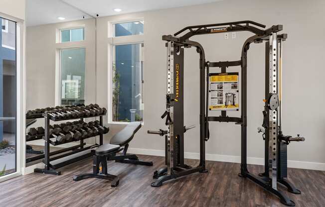 a home gym with a variety of exercise equipment at Loma Villas Apartments, San Bernardino, CA