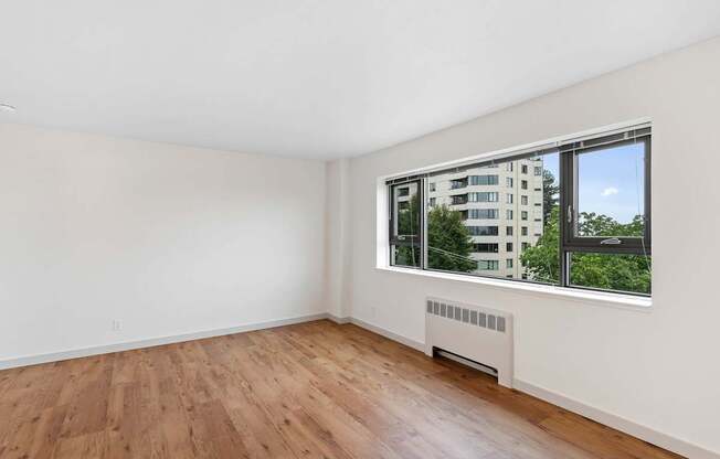 a living room with wood floors and a large window