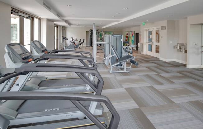 a gym with treadmills and other exercise equipment