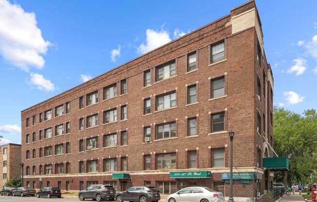 a large brick building with cars parked in front of it