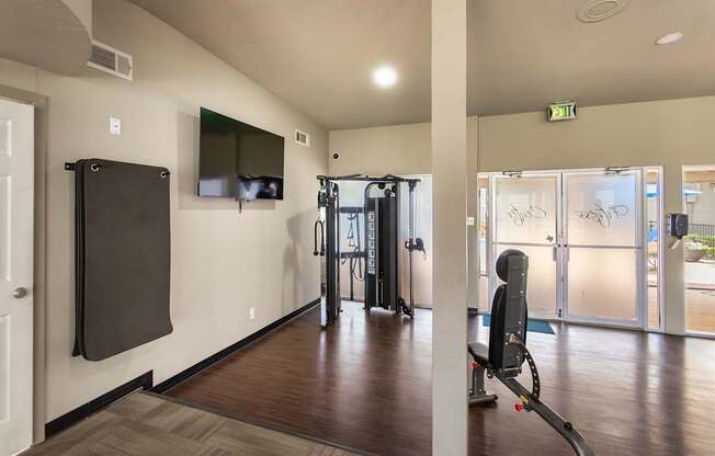 24-hour fitness center with a variety of equipment including treadmills, eliptical,and exercise balls at Princeton Court Apartments in the Vickery Midtown neighborhood of Dallas, TX.