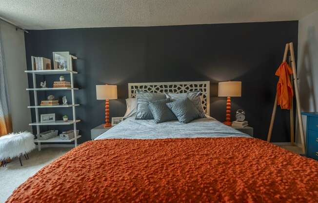 a bedroom with a bed and two nightstands