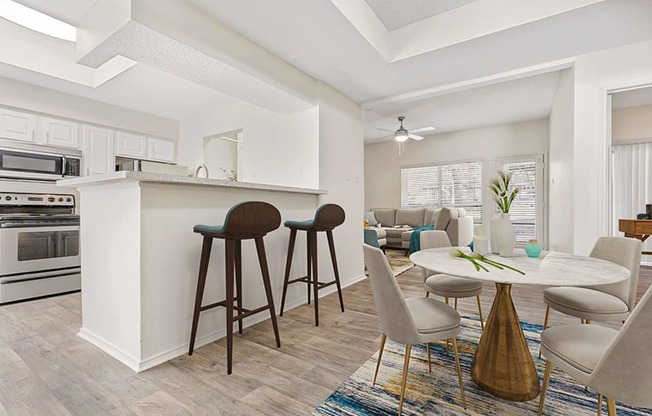 a living room with a kitchen and a dining table