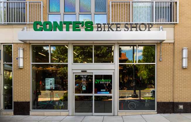 the front of a converse bike shop with a sign above the door