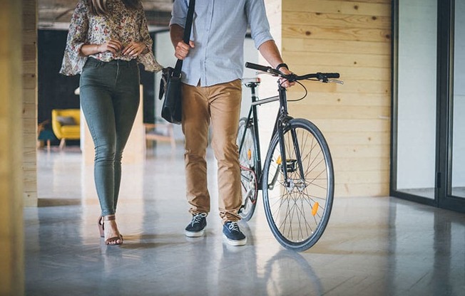 Metro Fremont | Apartments |  couple walking with bike