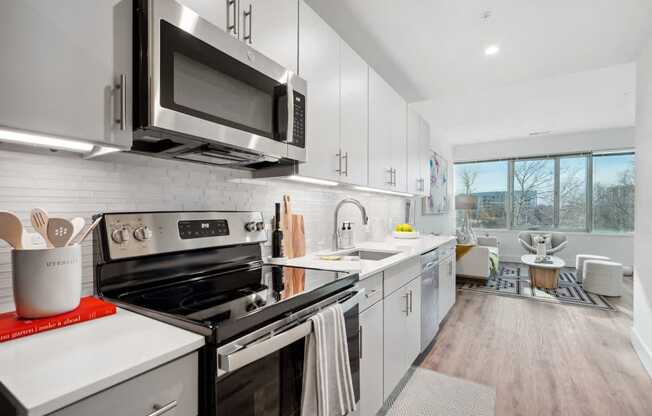 a kitchen with a stove and a microwave at Sinclaire on Seminary, Virginia 