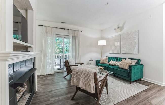 a living room with a fireplace and a green couch