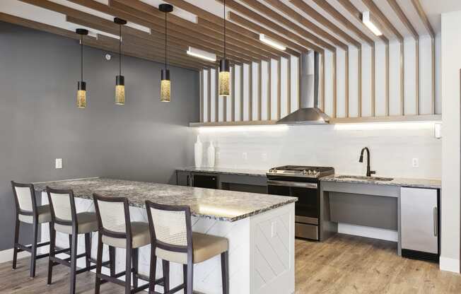 a kitchen with a large island and a stove top oven