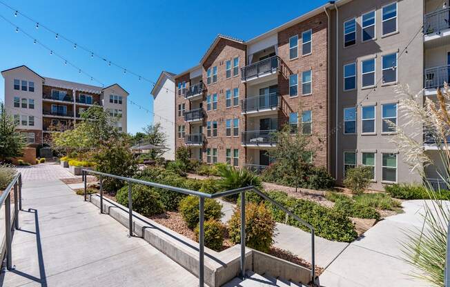 steps leading up to an apartment building with stairs and landscaping