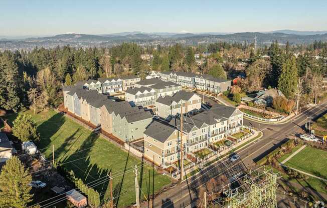 A large building complex with a parking lot in front.