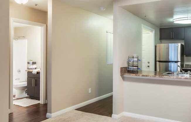 Living room and a kitchen with a ceiling fan at Ascend2300, 92008 