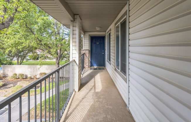 the view from the front porch of a house with a blue door