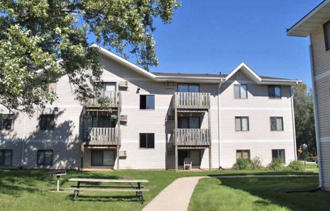 an apartment building with a picnic table in front of it
