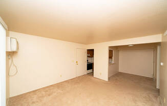 Empty dining room with a breakfast bar and plush carpet at Trappers Cove Apartments, Lansing