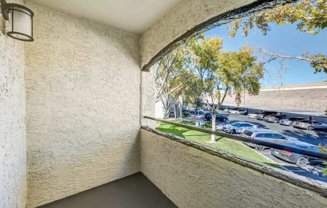 a balcony with a view of a parking lot