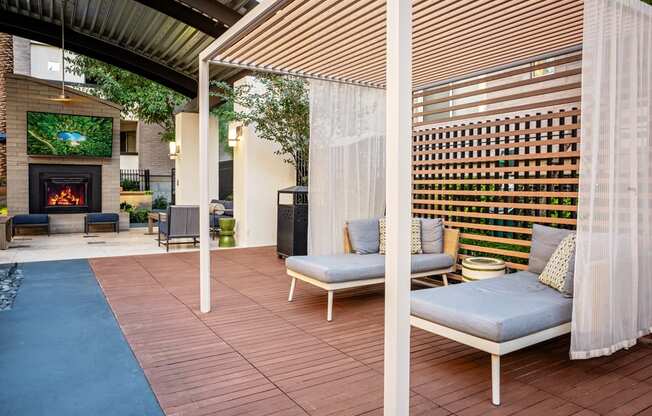 A patio with a fireplace and a sofa.