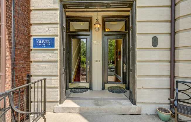 Oliver apartment entrance with a sign on the wall.