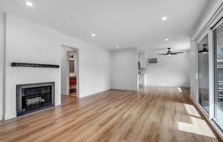 a living room with a fireplace and a wooden floor