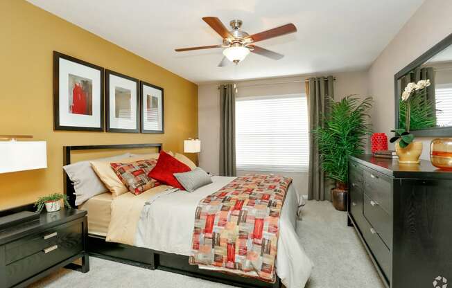 a bedroom with a bed and a ceiling fan