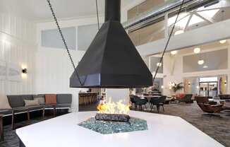 a large white table with a fireplace in a lobby