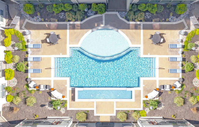 a rendering of an aerial view of a swimming pool with trees and umbrellas