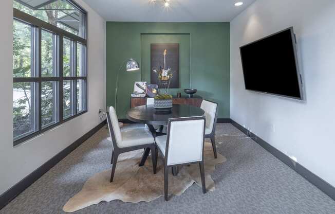 a dining room with a table and chairs and a television at The Hendrix, Atlanta, GA, 30329