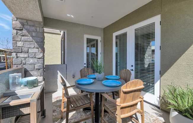 A patio with a table and chairs.