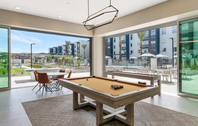 Resident lounge space with billiards table at Glen 91 Apartments in Glendale, AZ