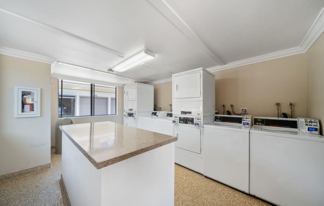 a kitchen with an island and washer and dryer