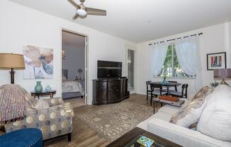 a living room filled with furniture and a flat screen tv