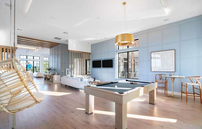 A room with a pool table and a chair.