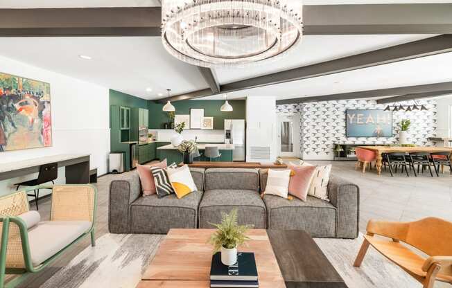 a living room filled with furniture and a large chandelier