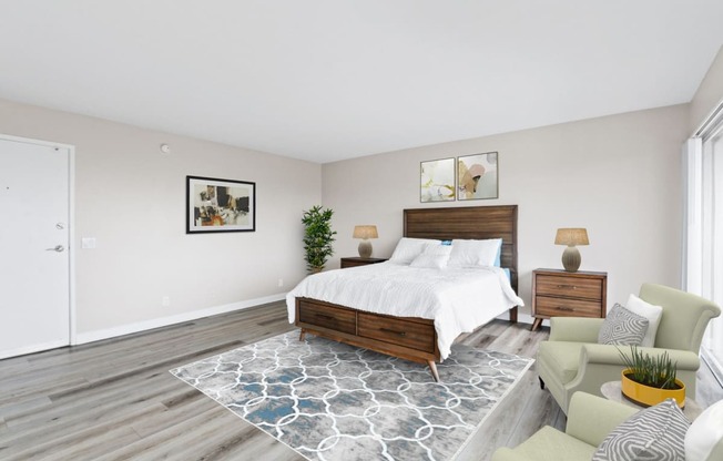 a bedroom with a bed and a chair in a 555 waverly unit