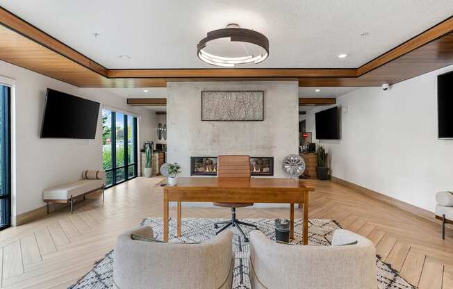 a living room with a fireplace and a table and chairs