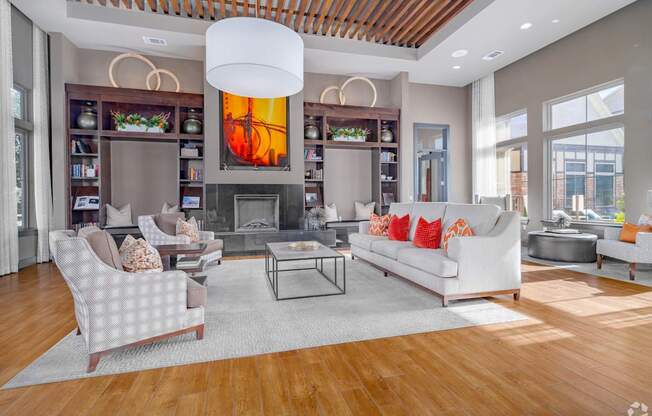A modern living room with a fireplace and a large painting above it.