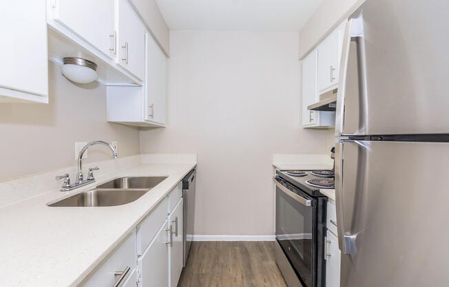 a kitchen with a sink and a refrigerator